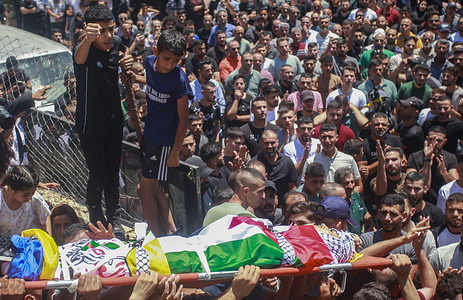 (EDITOR'S NOTE: Image depicts death)
A Palestinian child looks sad while bidding farewell to the body of a 18-year-old Palestinian teenager, Fawzi Makhalfeh, who was shot dead by Israeli soldiers on patrol, during his funeral in the village of Sebastia, west of Nablus, in the occupied West Bank. Eyewitnesses said Israeli soldiers opened fire on a car of the Palestinian Fawzi Makhalfeh, who was on his way to relax in the Antiquities Square near Sebastia.