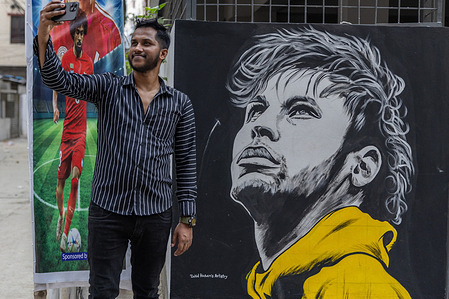 A man seen taking a selfie with a graffiti of the famous football star, Neymar Júnior, on a wall in an alley ahead of the FIFA World Cup 2026.