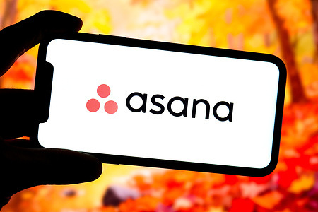 In this photo illustration, the logo of Asana is displayed on the screen of a smartphone.