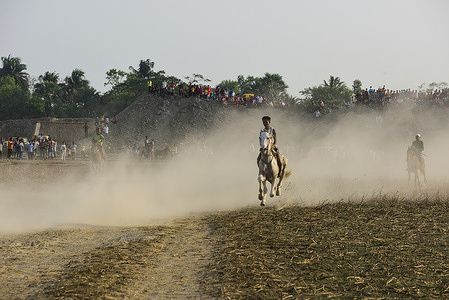 Children Jockeys ride horses without proper safety equipment's during a Horse Race in Rural Bengal.