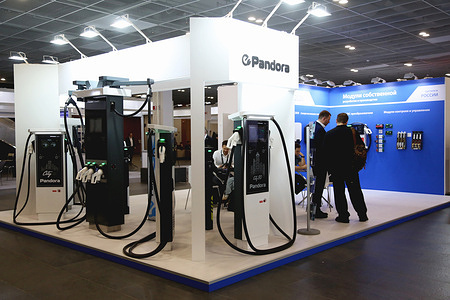 Visitors consult with staff at a local vendor Pandora booth during 7th International Exhibition & Forum for Energy Saving, Green Energy and Electric Vehicles in Moscow. RENWEX. Energy Saving, Green Energy and Electric Vehicles features an international exhibition and specialised forum. It runs under the slogan "Creating the future of renewable energy together" and bring together 82 participants from 5 countries