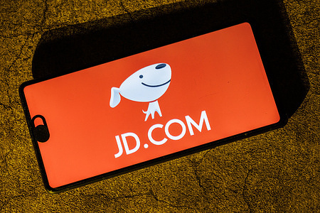 In this photo illustration, the JD.com app logo is seen displayed on a mobile phone. JD.com is scheduled to report its Q1 2025 earnings on Tuesday, May 13, 2025, before the U.S. market opens. The earnings conference call is set for 8:00 PM HKT (1:00 PM BST) on the same day. JD.com (京东) is one of China’s largest e-commerce companies, founded by Liu Qiangdong (Richard Liu) in 1998. Headquartered in Beijing