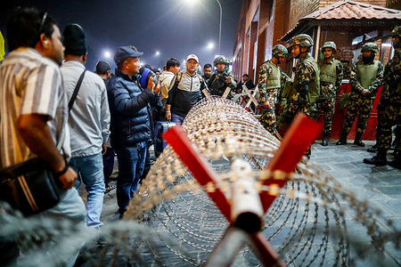Army personnel inform passengers bound for the Middle East about flight cancellations at Tribhuvan International Airport after flights were disrupted due to regional airspace closures following escalating tensions and military strikes involving Iran, Israel and the United States.