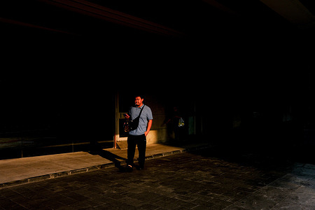 A man is seen with a cigarette in his mouth.