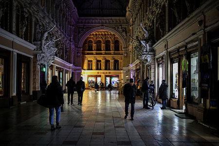 People are seen walking inside the Passage Hotel on Preobrazhenskaya Street. As a result of a massive missile attack by the Russian Federation on November 15, several large Ukrainian cities were left without electricity. The shortage of electricity is also felt in Odessa. Many shops and businesses are now using electric generators.