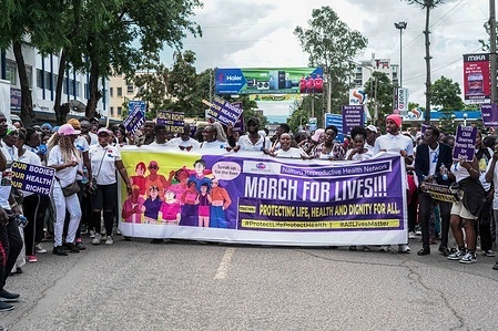 Activists chant slogans and hold a banner while protesting against raising cases of societal injustices in Kenya.