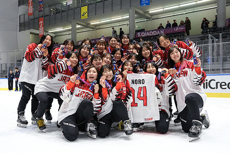Japan's team pose for a photo at the Women's Hockey Award Ceremony in the FISU Winter World University Games. Czech Republic wins the gold medal, Canada is second with the silver medal and Japan third with the bronze medal.