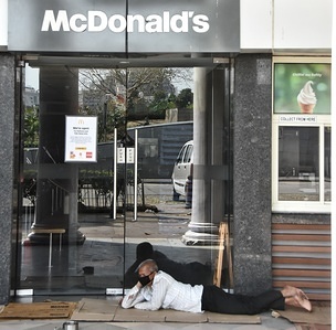 A homeless man rests at a closed McDonald's door during the first day of the civil curfew.
The Indian government imposed a nationwide Janata (civil) curfew as a preventive measure against the COVID-19 virus that is regarded as a pandemic.