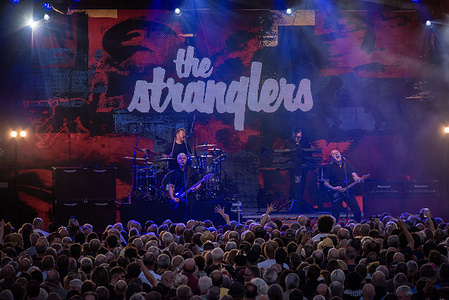 The Stranglers perform on the stage in Margate. Thousands of punk rockers and skinheads gathered at the Dreamland amusement park in Margate, UK. Because of Buzzcocks and The Stranglers are on tour in the UK. Both punk rock bands have been formed back in the 1970's.