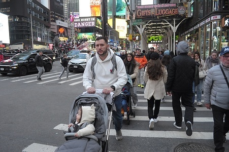 People walk in Times Square, Manhattan, New York City.