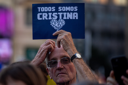 A protester carries a placard during a demonstration by Argentine residents in Spain in support of Cristina Kirchner.