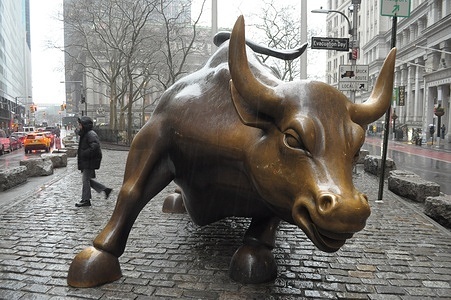 The "Charging Bull" statue is seen in the rain in the Financial District in Manhattan, New York City.