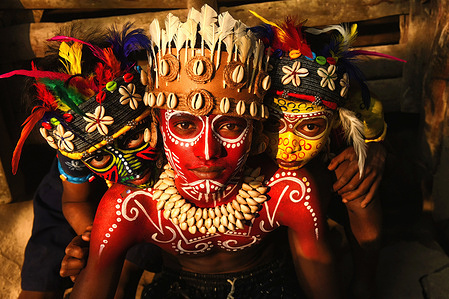 Young children pose with their faces painted as part of their Impersonating Act on the theme of different Tribal Cultures. For generations Bahurupi artists from West Bengal have been practicing in the art of face painting. Using their painting techniques they can easily metamorphose into different characters during a performance, which often represents tribal myths. These traditional artists scrape a living from their performances, relying on the generosity of audiences for their income.