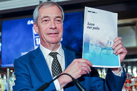 Reform UK leader Nigel Farage MP holds a copy of the five point 'Save Our Pubs' document at a press conference at a central London pub.