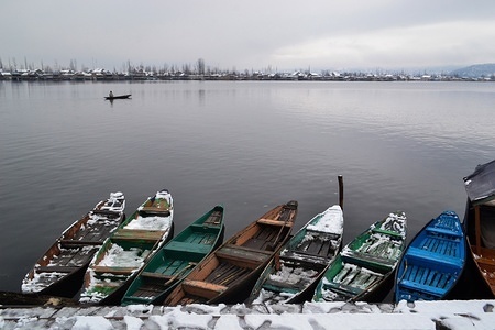 Boats are moored to the bank of Dal Lake during snowfall in Srinagar, Indian administered Kashmir. Moderate to heavy snowfall started in the valley on Monday ended an unusually long dry spell in Kashmir.
The snow and rain is likely to continue till Tuesday, the weather office said.