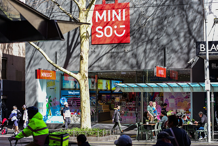 People are seen walking in front of MINISO store on the streets of Melbourne CBD.