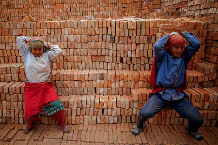Top Bahadur Gharti, 25-years old, and his wife Amrita Gharti 24-years old, stack bricks from their backs on Valentine's Day at Brick Kiln. They have been married for eight years after developing a liking for each other when they met at a relative’s place in Surkhet. Top Bahadur Gharti and his wife Amrita Gharti relocate to work and reside at a brick kiln for four months during the winter, which marks the brick-making season. Following this period, they return to their village with their earnings. Despite earning approximately eighty thousand rupees during a season, they manage to save only around forty thousand rupees (US $480). Each day of their shift, they receive around a thousand rupees by filling their payslip with stamps for carrying bricks on their backs throughout the day. The couple, who reside in Surkhet, have three children.