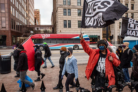 Demonstrators hold Black Lives Matter flags walking in front of the Ohio Statehouse. 

Activist groups in Columbus came together to form the 'United Front Against the Far-Right and Capitalist System!' This demonstration began at Columbus City Hall, marched to the Columbus Statehouse and concluded with a march back to Columbus City Hall. Left wing activist groups organized this event, because they felt they needed to make their presence known to the Far-Right after supporters of the previous president, Donald J. Trump, breached the Capitol of the United States on Jan. 6, 2021.