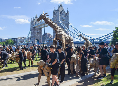 Puppeteers take life-size animal puppets for a walk near Tower Bridge as part of 'The Herds' art and climate action which will see the puppets travel 20,000 km from the Congo Basin to the Arctic Circle symbolising the 'flight from climate disaster'.