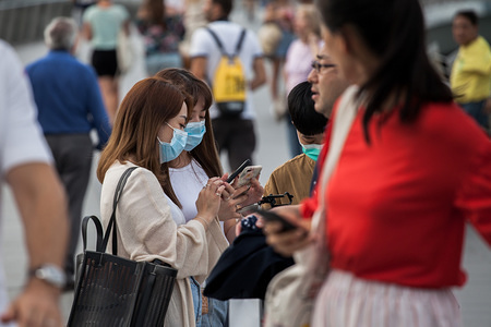 People wearing protective surgical masks visit the Merlion Park, a major tourist attraction in Singapore.
Singapore declared the Coronavirus outbreak alert as Code Orange on February 7, 2020.