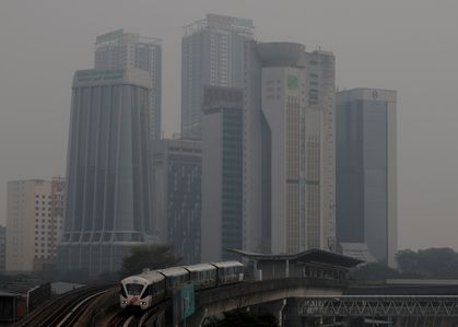 A train passes through a haze-shrouded Kuala Lumpur, as air quality deteriorates nationwide and unhealthy readings are recorded. Smoke haze from land and forest fires in neighboring Indonesia degraded air quality across Malaysia, pushing pollution to unhealthy levels in Kuala Lumpur and multiple states. Carried by regional monsoon winds, the transboundary smog forced school closures and triggered health warnings as authorities monitored rising particulate pollution.