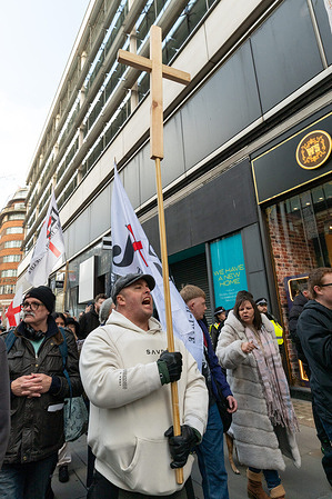 A supporter holding a crucifix during the march. Supporters of the UK Independence Party (UKIP) took part in a religious march through central London, assembling at Marble Arch before proceeding along Oxford Street toward Trafalgar Square. The procession, promoted as a Christian prayer march, was led by UKIP figure Nick Tenconi, with participants carrying crosses, Christian symbols, and reciting prayers and devotions.
