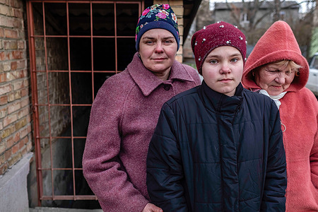 A girl and her relatives in front of the shelter where she and her family lived for 36 days during the Russian occupation. Bucha, a town on the outskirts of the Ukrainian capital Kyiv, was controlled by Russian soldiers for about a month. Its liberation on March 31 revealed some of the cruellest atrocities committed by Russian soldiers during the occupation. Buildings were destroyed, and houses looted. Dead bodies were found in Bucha streets, buildings and mass graves.