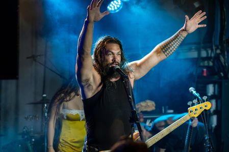 Jason Momoa seen on stage performing with the band Öof Tatata during a concert. The band ÖOF TATATÁ featuring Jason Momoa, Mike Hayes and Kenny Dale performed at Dingwalls concert in London as part of Meili Fest presented by Spirits of Anarchy.