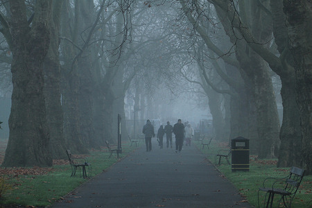 People walk through the morning fog in Plashet Park, Newham.
Most parts of London were engulfed in fog.