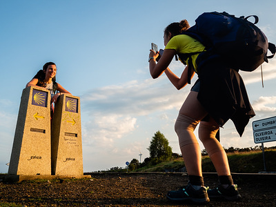 A pilgrim is seen taking a photo of another pilgrim where the Finisterre and Muxia routes split. Cape Finisterre is the destination of those pilgrims who, after visiting the St James’ tomb is Santiago, continue their way along the route marked out for them overhead by the Milky Way until they could go no further. Finisterre was considered during the period of Classical Antiquity to be the end of the known world. Finisterre, or Fisterra in Gallego, the local Galician dialect, means "Land's End" in Latin. Next, to the lighthouse, there is the 0.0 Kilometer Marker from where the Atlantic Ocean can be seen it. This place is also very popular for its amazing sunsets.
