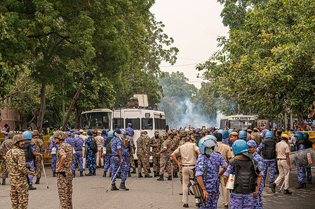 Rapid Action Force (RAF) personnel fire tear gas shells to disperse protesters marching towards Parliament during a demonstration organized by the Cockroach Janta Party (CJP). The protesters had been staging a sit-in at the protest site for nearly 30 days before announcing a march toward the Indian Parliament. They demanded the resignation of Union Education Minister Dharmendra Pradhan over alleged examination irregularities and called for the release of activist Sonam Wangchuk, who was taken into custody and hospitalized following a prolonged hunger strike.