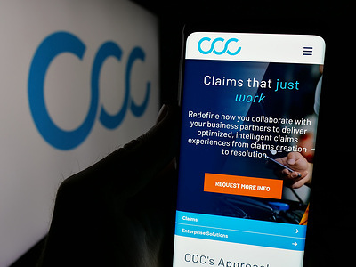 In this photo illustration, a person is holding a smartphone with the web page of US software company CCC Intelligent Solutions Inc. on screen with logo.