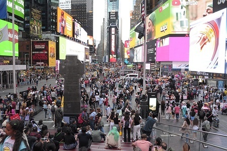 People walk in Times Square, Manhattan, New York City.