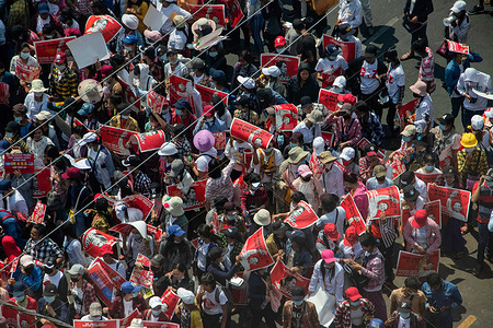 Anti military coup protesters seen holding Aung San Suu Kyi portraits during a demonstration against the military coup.
Myanmar police fire rubber bullets, real bullets, tear gas and sound bombs at peaceful anti military coup protesters on Sunday, Hundred were arrested, including 50 medical staff and 1 journalist. At least 23 has been shot and killed across the country as Myanmar enter the bloodiest day since the military coup on 1st February 2021.
Myanmar's military detained State Counsellor of Myanmar Aung San Suu Kyi on February 01, 2021 and declared a state of emergency while seizing the power in the country for a year after losing the election against the National League for Democracy (NLD).