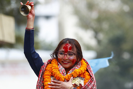 Rastriya Swatantra Party (RSP) candidate Toshima Karki rings a bell as she celebrates with supporters after winning a second term in parliament from Lalitpur-3 in the House of Representatives election.