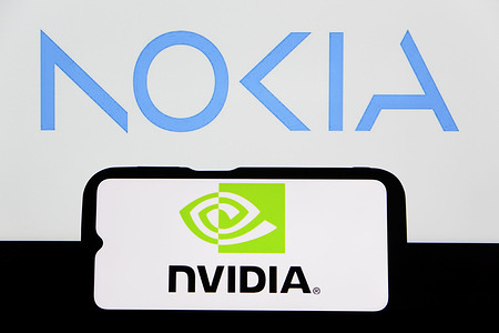 In this photo illustration, the NVIDIA logo is displayed on a smartphone with Nokia logo in the background.