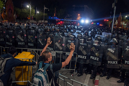 Riot police stand on guard during the demonstration.Thousands of Thai anti-government protesters move from the democracy monument to The Thai Government House in Bangkok and prepared to stay-overnight here. They demonstrated demanding the resignation of Thailandís prime minister, Prayuth Chan-ocha, and reforms to the monarchy.