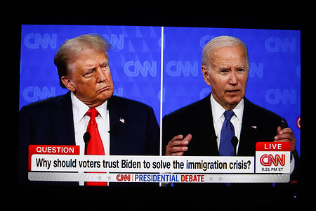 In this photo illustration, a screen shows the first presidential debate between US President Joe Biden and former President Donald Trump in the CNN studio in Atlanta.