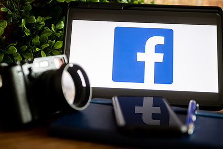 In this photo illustration, a Facebook logo seen displayed on a tablet.