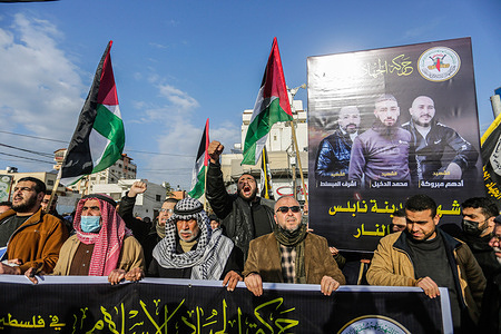 Palestinians in Gaza chant their rally cry against Israeli occupation during the funeral.
Palestinians in Gaza City mourn over the three Palestinians killed in Nablus. Israeli forces killed three Palestinians on February 8 during a daytime raid in the West Bank city of Nablus.