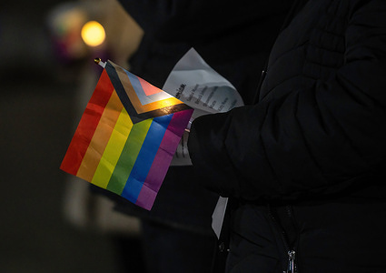 A woman holds a Pride flag during the vigil. A crowd gathered at the Public Square for a Transgender Day of Remembrance Sunday evening. The vigil was to bring light to the rights of transgender people after a shooting at a gay club in Colorado.