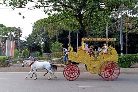 A family rides on a horse carriage in Manik Mia Avenue amid the coronavirus pandemic.