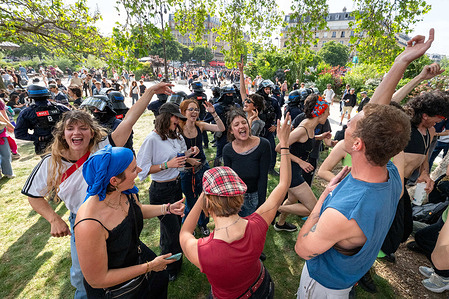 Protesters dance in Place de la Nation while being observed by the police. Demonstrators took part in the annual May Day march organised by trade unions across Paris, marking International Workers’ Day with rallies and processions through the city. Protesters gathered to advocate for labour rights, wages and social protections, as police intervene to disperse sections of the crowd using tear gas and charging protesters during the clashes along the route.