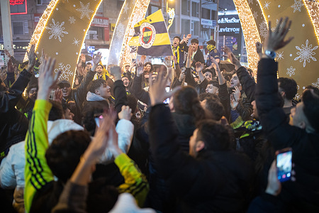 The fans cheer their team. Fenerbahce fans gathered at the Kadikoy Bull statue to celebrate after defeating Galatasaray 2-0 in the Turkcell Super Cup Final to win the trophy.