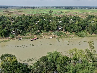(EDITOR'S NOTE: Image taken with a drone) 
General view of the Shidhulai Swanirvar Sangstha floating school in the Chalan Beel area of Pabna. In Bangladesh’s Chalan Beel wetlands, seasonal floods often cut children off from schools for months. To adapt to the changing climate and frequent flooding, solar-powered floating schools bring classrooms directly to remote communities by boat. The floating schools allow children to continue their education during the monsoon season when roads disappear underwater. Beyond education, the boats also support climate resilience by providing access to books, digital learning, and community services in flood-prone areas.