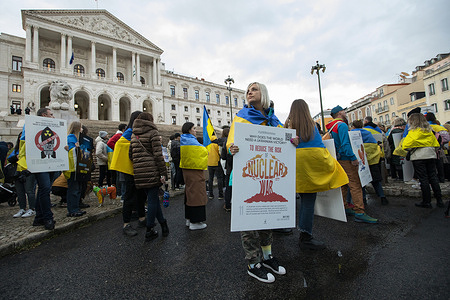 Protesters seen holding placards during the anti war protest in Lisbon. On the day that marks one year since the invasion of Ukraine by Russia, hundreds of people protested in Lisbon against the war.