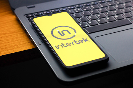 In this photo illustration, the Intertek logo is seen displayed on a smartphone screen.
