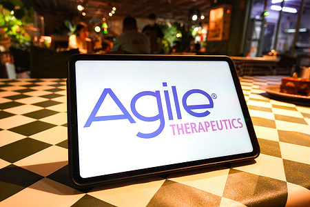 In this photo illustration, the Agile Therapeutics logo is displayed on the screen of the tablet.