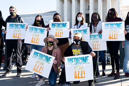 Protesters wearing face masks hold placards expressing their opinion in front of the Supreme Court during the demonstration.
Protest in favor of the Affordable Care Act (ACA) on the day that the Supreme Court is hearing arguments in a case regarding it.