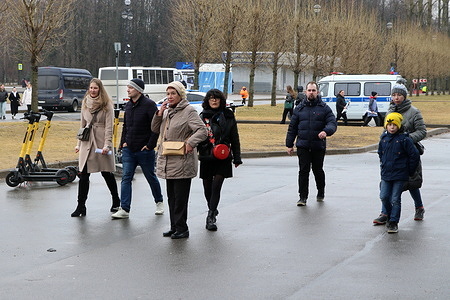 People and residents of the city walk in Primorsky Victory Park on a cloudy spring weather in Saint Petersburg.